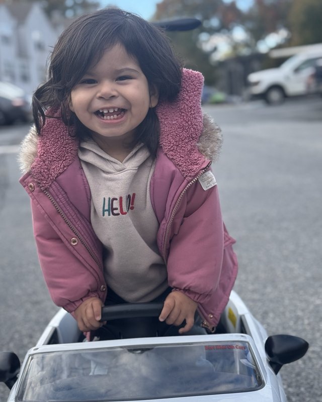 Eliany driving her little white car